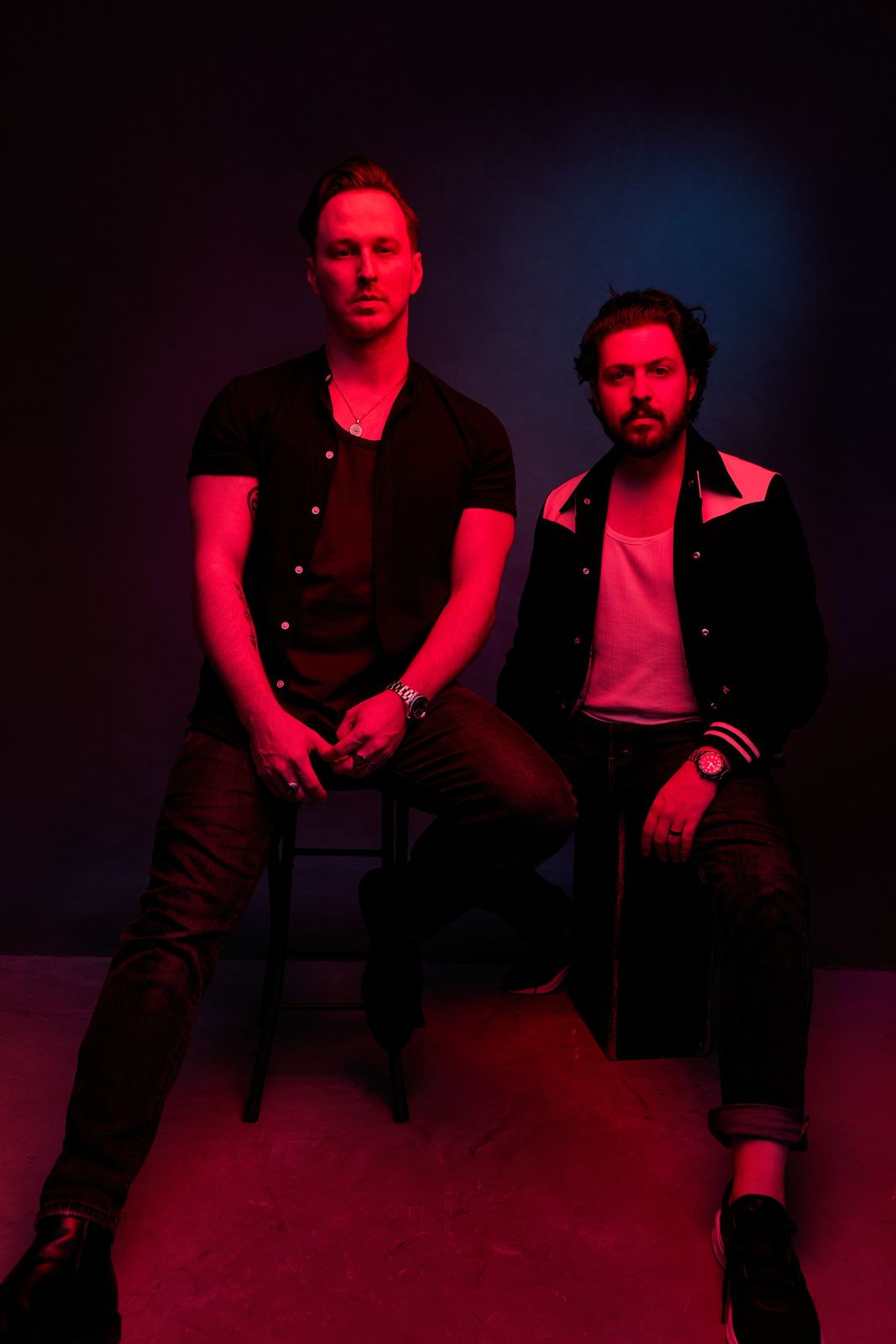 Coupe Marra, Tyler Anderson and Chris Jackson, seated under red and magenta light